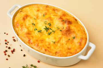 Casserole with mashed potatoes and spices on color background, closeup