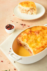 Casserole with mashed potatoes and spices on color background