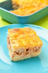 Plate with piece of mashed potato casserole on table, closeup