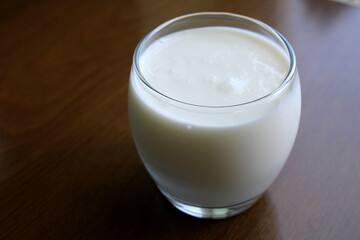 Glass of Kefir drink on wooden table, healthy drink 