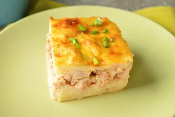 Plate with piece of mashed potato casserole on table, closeup