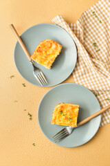 Plates with pieces of mashed potato casserole on color background
