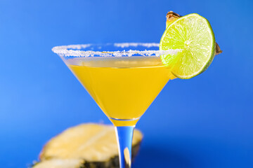 Glass of pineapple daiquiri cocktail on color background