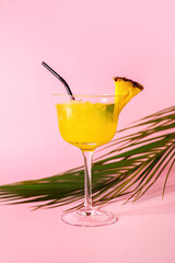 Glass of pineapple daiquiri cocktail on color background