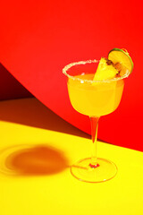 Glass of pineapple daiquiri cocktail on color background