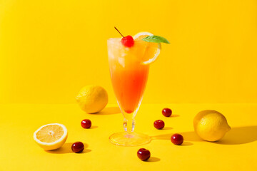 Glass of tasty summer cocktail on color background