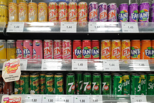 Assorted brands of carbonated soft drinks on the display shelf in Aeon grocery, Penang. Aeon is Japan's single-largest shopping mall developer and operator. PENANG, MALAYSIA - 29 JULY 2021.