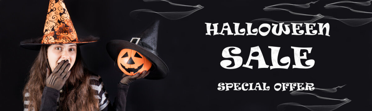 Halloween sale banner special offer. A woman in a witch costume holds a pumpkin lantern jack and covers his mouth with his hand.