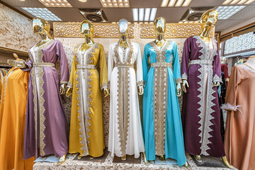 Traditional Middle Eastern and Arab women's dresses and robes on mannequins on the market