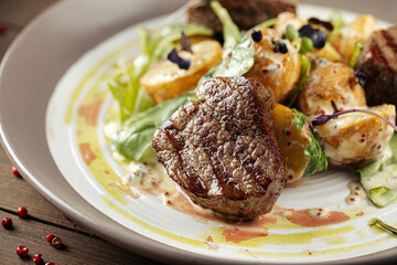 Closeup on a plate of gourmet fillet mignon steaks with potatoes 