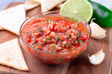 Tex-Mex cuisine salsa Asada sauce with roasted vegetables, served with tortilla chips and lime,...