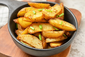 Baking dish with tasty potato on table, closeup
