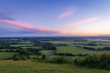 Fototapeta na wymiar blue hour and a purple sky over the Kent countryside from the top of the Wye downs south east England