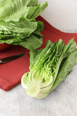Fresh romaine lettuce on light background, closeup