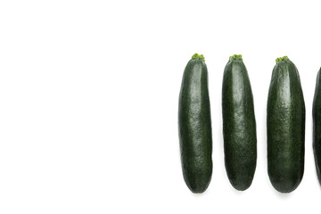 Fresh zucchini squashes on white background