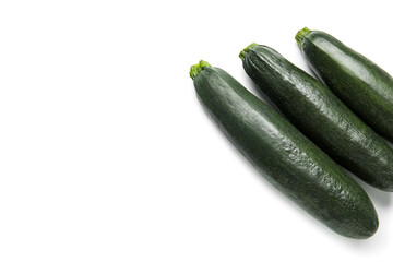 Fresh zucchini squashes on white background