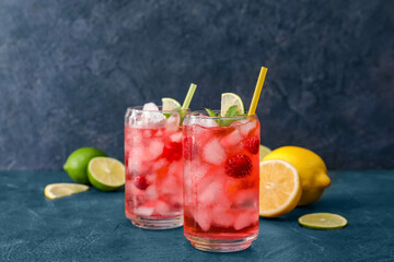 Glasses of delicious raspberry lemonade on color background