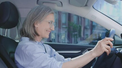 Cheerful adult woman enjoying interior of her new car, automobile saloon leasing