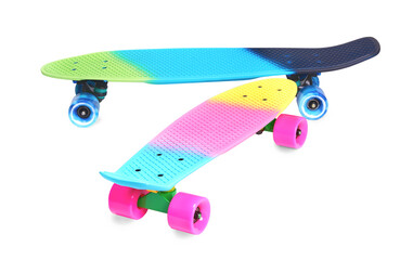 Two neon rainbow colored Penny board skateboards isolated on white background. Plastic mini...