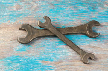 Set of two vintage bronze wrench on shabby background
