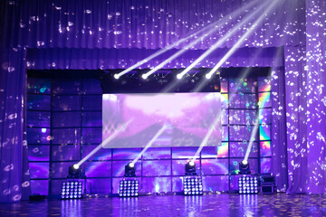 Scene in violet light with spotlights.