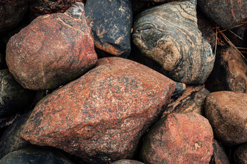 Nature background of rocks and pebbles on the beach, sea rocks in close up view