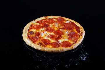Pizza with mushrooms, sausage and olives on a wooden background