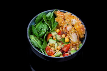 Salad with crab meat in batter and fresh vegetables on a black background © Pretti