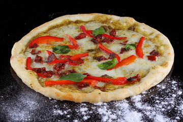 Pizza with mushrooms, sausage and olives on a wooden background