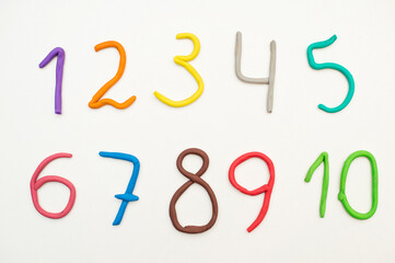 Colorful digits made from plasticine. Bright colored volumetric figures for children (isolated on white)