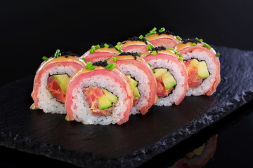 Rolls with red caviar on a black background