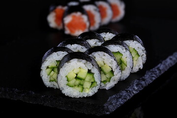 Rolls with red caviar on a black background
