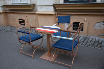 4 blue chairs at a colorful table on the street in Timisoara, Romania, 2021