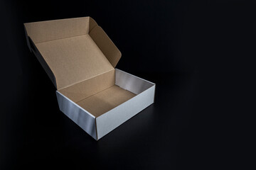 open cardboard box on black background
