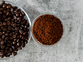 Coffee powder in bowl with defoused beans in saucer.