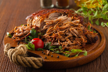 Pulled pork on a wooden board.