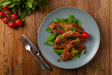 Saltimbocca. Veal schnitzel with sage and Parma ham. Italian specialty. Top view.