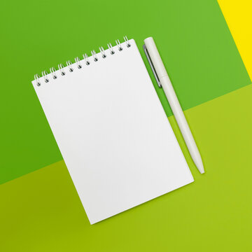 Notepad and pens on multicolor background