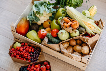 Closeup of box full of various organic vegetables, fruits and berries. Food delivery concept.