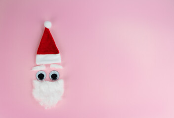 Funny santa claus head on pink background, copy space