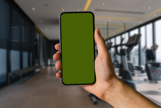 Hand held smartphone screen in the Gym in the morning light.