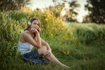 Obraz premium Photo of a beautiful girl with a flower in her hair.
