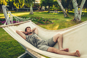 person relaxing in hammock