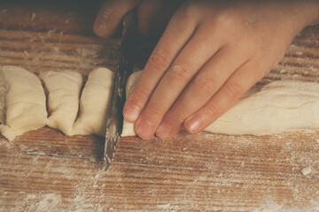 Top view of young girl with a knife making homemade dumplings. Dumplings with potatoes and cheese stuffing. National food, eating, delishion, diet concept.