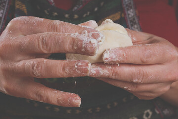 Beautiful young woman making homemade dumplings. Dumplings with potatoes and cheese stuffing. National food, eating, delishion, diet concept.