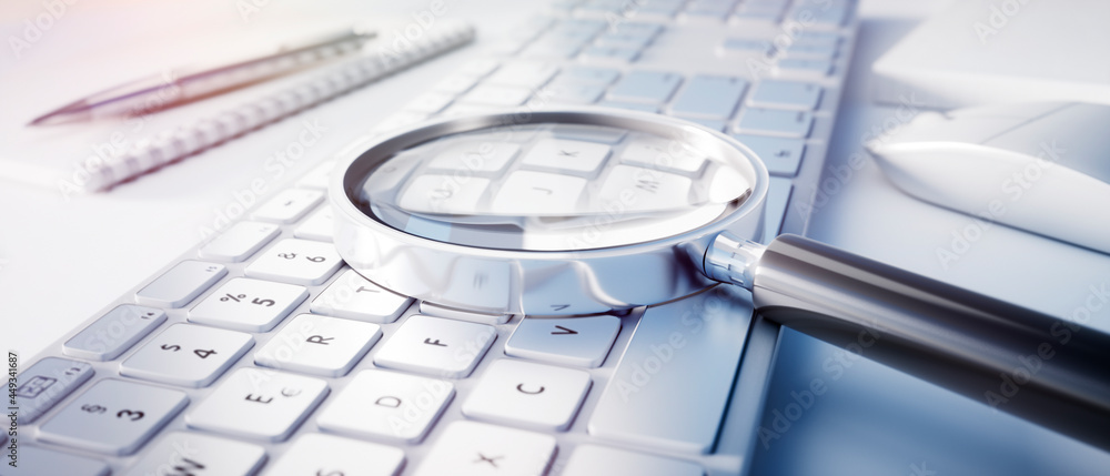 Wall mural magnifying glass on computer keyboard - search technology concept