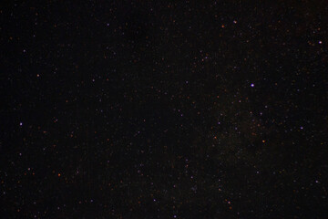 Fototapeta na wymiar Multicolored stars in the night sky.