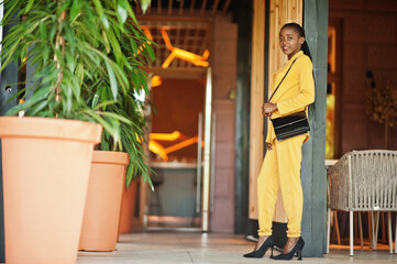 Portrait of nice-looking fashionable attractive lovely content cheerful cheery african american girl wear bright vivid shine vibrant yellow color jacket or costume.