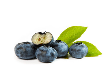 Fresh blueberries (Cyanococcus within the genus Vaccinium) with sliced berry and green leaves isolated on white background. 
