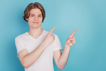 Happy guy isolated select ads showing pointing with finger blue empty space background